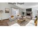 Virtually staged living room featuring a brick fireplace and modern decor at 6782 Bonillo Dr, Las Vegas, NV 89103