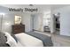 This virtually staged main bedroom features a neutral color palette, a walk-in closet, and an ensuite bathroom at 6782 Bonillo Dr, Las Vegas, NV 89103