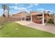 Well-maintained backyard boasts a covered patio, a grassy lawn, and desert landscaping at 7904 Mountain Point Ave, Las Vegas, NV 89131