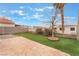 Artificial lawn and stone hardscape backyard in a desert landscape at 7904 Mountain Point Ave, Las Vegas, NV 89131