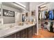 Bathroom featuring double sinks, a large mirror, and access to a closet at 7904 Mountain Point Ave, Las Vegas, NV 89131