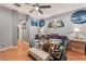 Bright bedroom with hardwood floors, fan, and natural light at 7904 Mountain Point Ave, Las Vegas, NV 89131