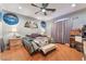 Cozy bedroom featuring a ceiling fan, warm wood floors, and unique wall decor at 7904 Mountain Point Ave, Las Vegas, NV 89131