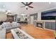 Open concept living area with wood floors, fireplace, and breakfast bar with seating at 7904 Mountain Point Ave, Las Vegas, NV 89131