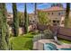 Backyard with a view of the spa, lush landscaping, and view of the home's rear exterior at 8425 Cambrils Ave, Las Vegas, NV 89178