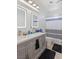 Bathroom featuring double vanity, two large lit mirrors, and modern fixtures at 8425 Cambrils Ave, Las Vegas, NV 89178