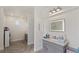 Bright bathroom with a gray vanity and marble countertop plus an arched window for natural light at 8425 Cambrils Ave, Las Vegas, NV 89178