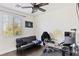 Well-lit home office/bedroom with a sleek desk setup and modern futon for relaxation at 8425 Cambrils Ave, Las Vegas, NV 89178