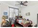 Fun bedroom with a dinosaur theme, featuring a ceiling fan and bright, colorful decor at 8425 Cambrils Ave, Las Vegas, NV 89178