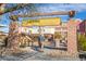 Inviting community entrance features decorative brick pillars and a welcoming overhead sign at 8425 Cambrils Ave, Las Vegas, NV 89178