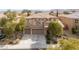 Two-story home featuring a three-car garage, neutral color scheme, and manicured landscaping in a suburban setting at 8425 Cambrils Ave, Las Vegas, NV 89178