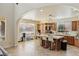 Open kitchen with island and bar stools, custom cabinets, and bright, airy atmosphere at 8425 Cambrils Ave, Las Vegas, NV 89178