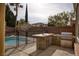 Outdoor kitchen featuring a built-in grill and counter space, near a fenced in pool at 8425 Cambrils Ave, Las Vegas, NV 89178