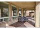 Spacious covered patio featuring large windows and stylish outdoor seating, perfect for relaxation at 8425 Cambrils Ave, Las Vegas, NV 89178