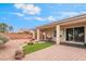Backyard featuring covered patio, outdoor kitchen, and low-maintenance desert landscaping at 8506 River Ridge Dr, Las Vegas, NV 89131
