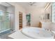 Luxurious primary bathroom with a glass shower and separate soaking tub at 8506 River Ridge Dr, Las Vegas, NV 89131