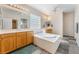 Bathroom featuring double sinks, soaking tub, and tile floors at 8506 River Ridge Dr, Las Vegas, NV 89131