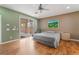 Bedroom featuring hardwood floors, ceiling fan, slider door, and neutral color scheme at 8506 River Ridge Dr, Las Vegas, NV 89131