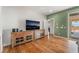 Spacious bedroom featuring hardwood floors, a TV, and slider door to backyard at 8506 River Ridge Dr, Las Vegas, NV 89131