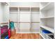 Spacious walk-in closet featuring built-in shelving and wood floors at 8506 River Ridge Dr, Las Vegas, NV 89131