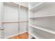 Large walk-in closet with custom built-in shelving and wood floors at 8506 River Ridge Dr, Las Vegas, NV 89131