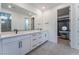 Modern bathroom showcasing dual sinks, white cabinets, and a door leading to a custom walk-in closet at 8648 Cloverbelle St, Las Vegas, NV 89166