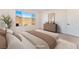 Bright bedroom with neutral color palette showcasing modern decor, a large window, and comfortable furniture at 8648 Cloverbelle St, Las Vegas, NV 89166
