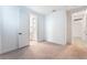 Bright bedroom showing bathroom entrance, neutral carpet, and fresh paint at 8648 Cloverbelle St, Las Vegas, NV 89166
