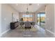 Staged dining room with modern table, chairs, and sliding door access to outdoor space at 8648 Cloverbelle St, Las Vegas, NV 89166