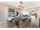 Dining area with modern table, chairs, and access to the outdoor space and kitchen at 8648 Cloverbelle St, Las Vegas, NV 89166