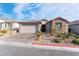 Charming single-story home featuring a well-manicured front yard, desert landscaping, and brick paved driveway at 8648 Cloverbelle St, Las Vegas, NV 89166