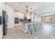 Modern kitchen with a large center island, stainless steel appliances, and elegant lighting fixtures at 8648 Cloverbelle St, Las Vegas, NV 89166