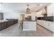 Spacious kitchen area with white cabinets, black countertops, and stainless steel appliances at 8648 Cloverbelle St, Las Vegas, NV 89166