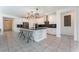 Kitchen with a large island, seating for four, stainless steel appliances, and modern lighting at 8648 Cloverbelle St, Las Vegas, NV 89166