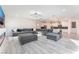 Open living space featuring a large sectional sofa, modern lighting, and a view into the kitchen at 8648 Cloverbelle St, Las Vegas, NV 89166