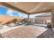 Inviting covered patio features a built-in grill, lounge chairs, and beautiful brick pavers at 8648 Cloverbelle St, Las Vegas, NV 89166