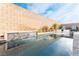 Stunning swimming pool with water feature, elegant seating and clear blue sky reflecting off the clear water at 8648 Cloverbelle St, Las Vegas, NV 89166