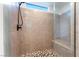 Modern walk-in shower features gray tile, a pebble floor, and a rainfall showerhead at 8648 Cloverbelle St, Las Vegas, NV 89166