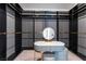 Spacious walk-in closet featuring custom shelving and a vanity area with a lighted mirror and stool at 8648 Cloverbelle St, Las Vegas, NV 89166