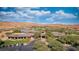 Aerial view of a community clubhouse with a golf course and mountain views in the background at 906 Majestic Vw, Mesquite, NV 89034