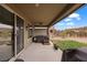 Covered back patio features a hot tub, ceiling fan and sliding glass door access to the home at 906 Majestic Vw, Mesquite, NV 89034