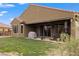 Spacious backyard with green grass, covered patio, barbecue grill, and hot tub at 906 Majestic Vw, Mesquite, NV 89034