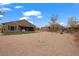 Large backyard with a combination of gravel, green grass, trees, and a well-maintained fence at 906 Majestic Vw, Mesquite, NV 89034
