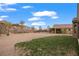 Large backyard with a combination of gravel, green grass, and a well-maintained fence at 906 Majestic Vw, Mesquite, NV 89034
