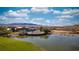 Luxury backyard with pool, lake view, and stunning mountain backdrop, perfect for outdoor living at 906 Majestic Vw, Mesquite, NV 89034