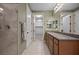 Well-lit bathroom with dual vanities, granite countertops, tile floors, and a view into a walk-in closet at 906 Majestic Vw, Mesquite, NV 89034