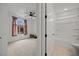 Bright bathroom with a shower-tub combo, white fixtures, and a window providing natural light with a view of the bedroom at 906 Majestic Vw, Mesquite, NV 89034