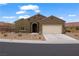 Charming single-story home with desert landscaping, arched entryway, and a spacious two-car garage at 906 Majestic Vw, Mesquite, NV 89034
