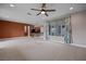 Open concept living room with plush carpeting, and view to a kitchen with an island and modern lighting at 906 Majestic Vw, Mesquite, NV 89034