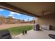Enjoyable covered patio with a hot tub and grill, offering outdoor relaxation with views of the landscaped backyard at 906 Majestic Vw, Mesquite, NV 89034